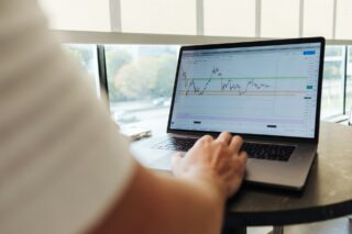 A person using a laptop to check analytics on a website.