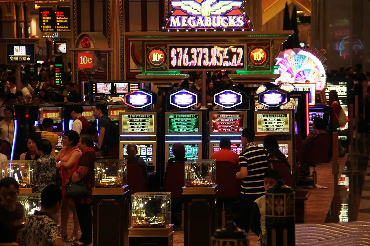 Photo of a people playing slot machines in a casino